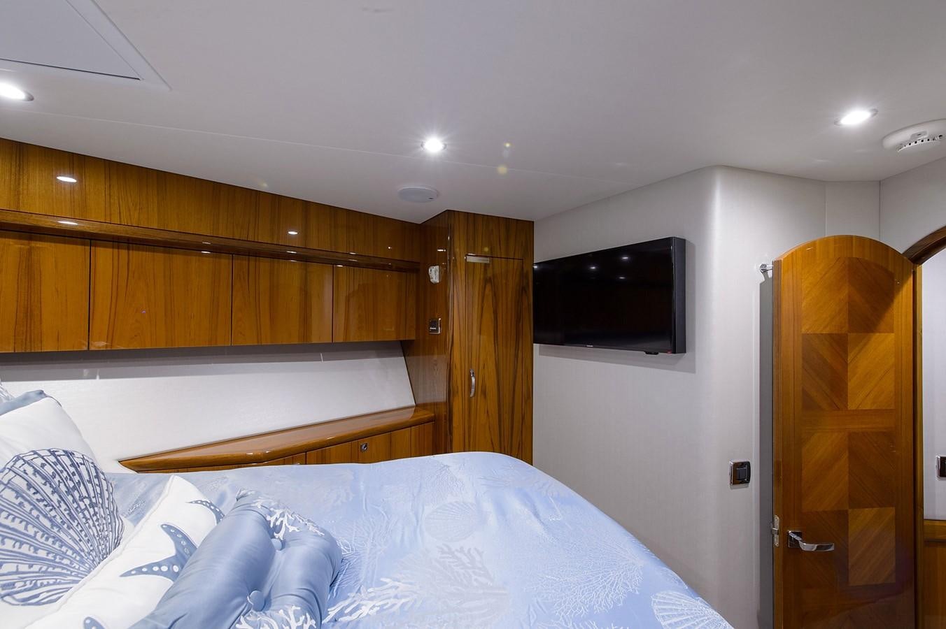 a bedroom with a bed and a television aboard NOTORIOUS Yacht for Sale