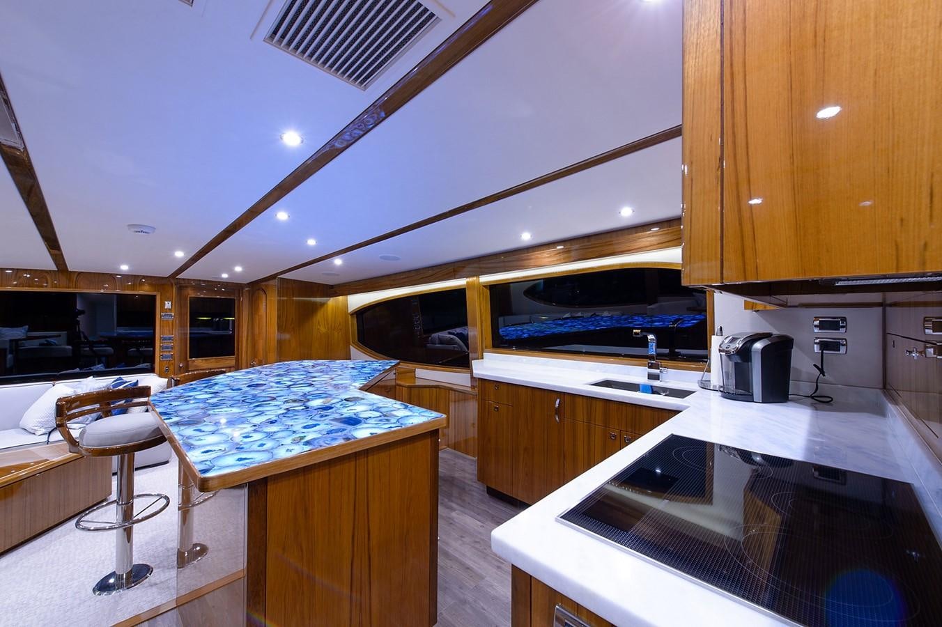 a kitchen with a bar and a bar aboard NOTORIOUS Yacht for Sale