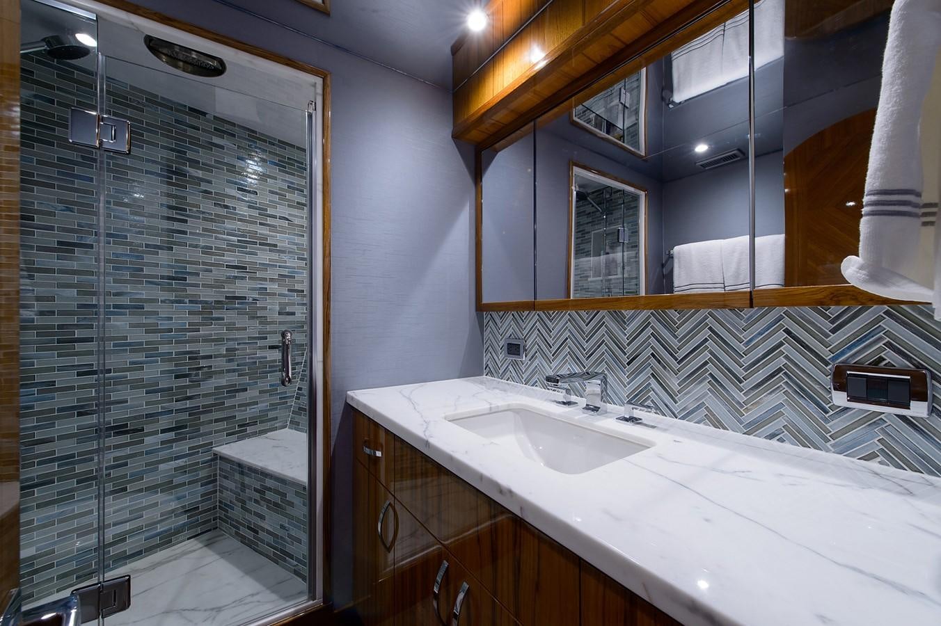 a bathroom with a glass shower aboard NOTORIOUS Yacht for Sale