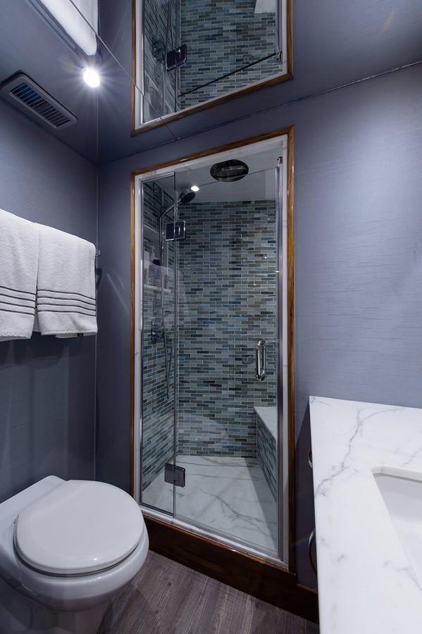 a bathroom with a glass shower aboard NOTORIOUS Yacht for Sale
