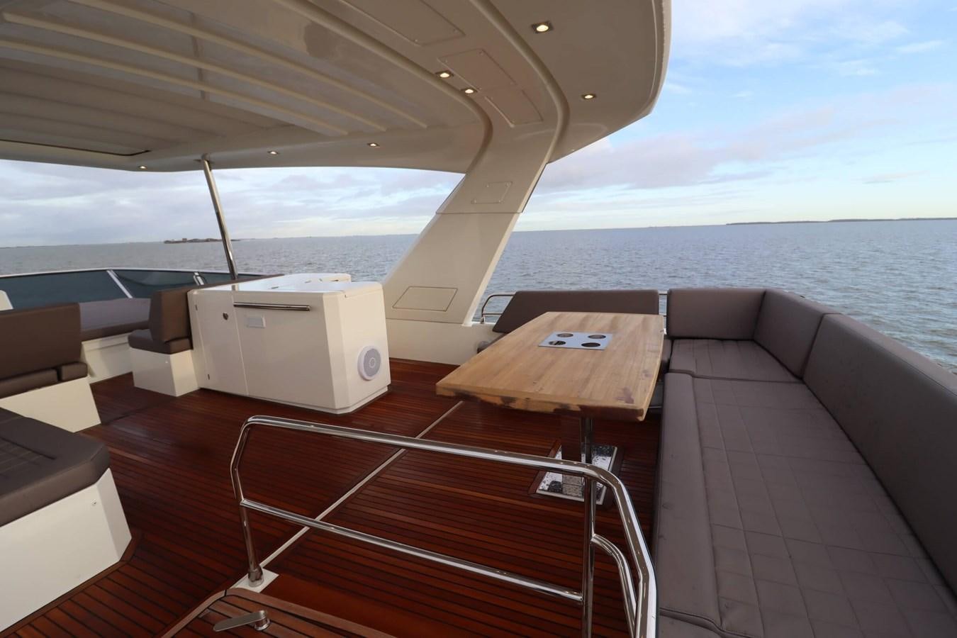 a boat with a table and chairs aboard PRESTIGE 680 FLY Yacht for Sale