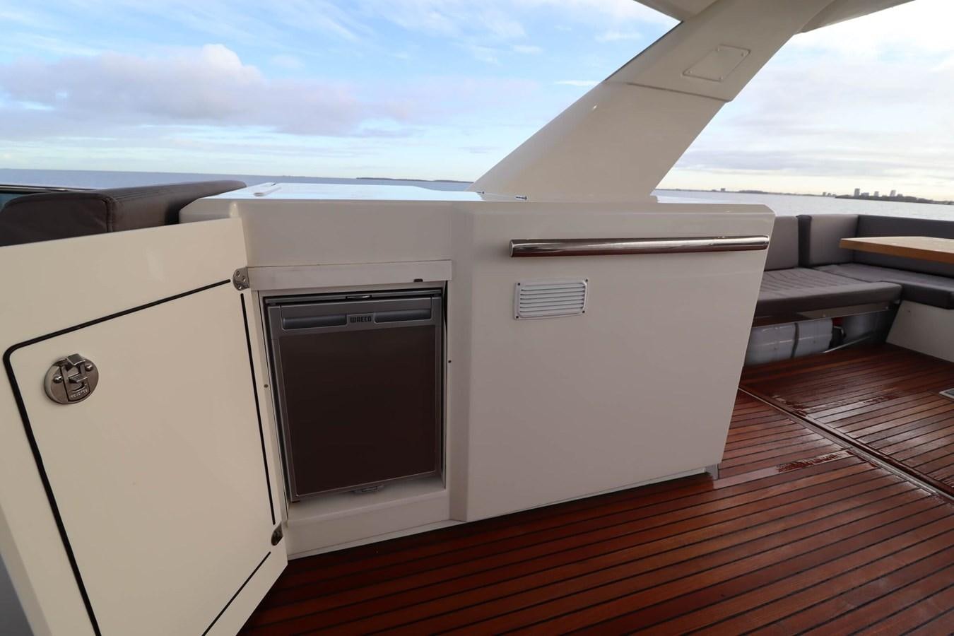 a white rectangular object on a wooden surface aboard PRESTIGE 680 FLY Yacht for Sale