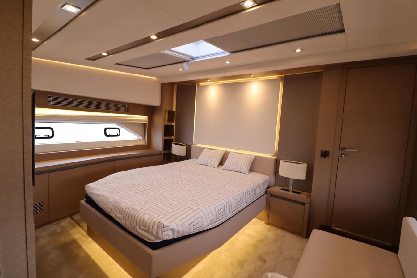 a room with a bed and a window aboard PRESTIGE 680 FLY Yacht for Sale