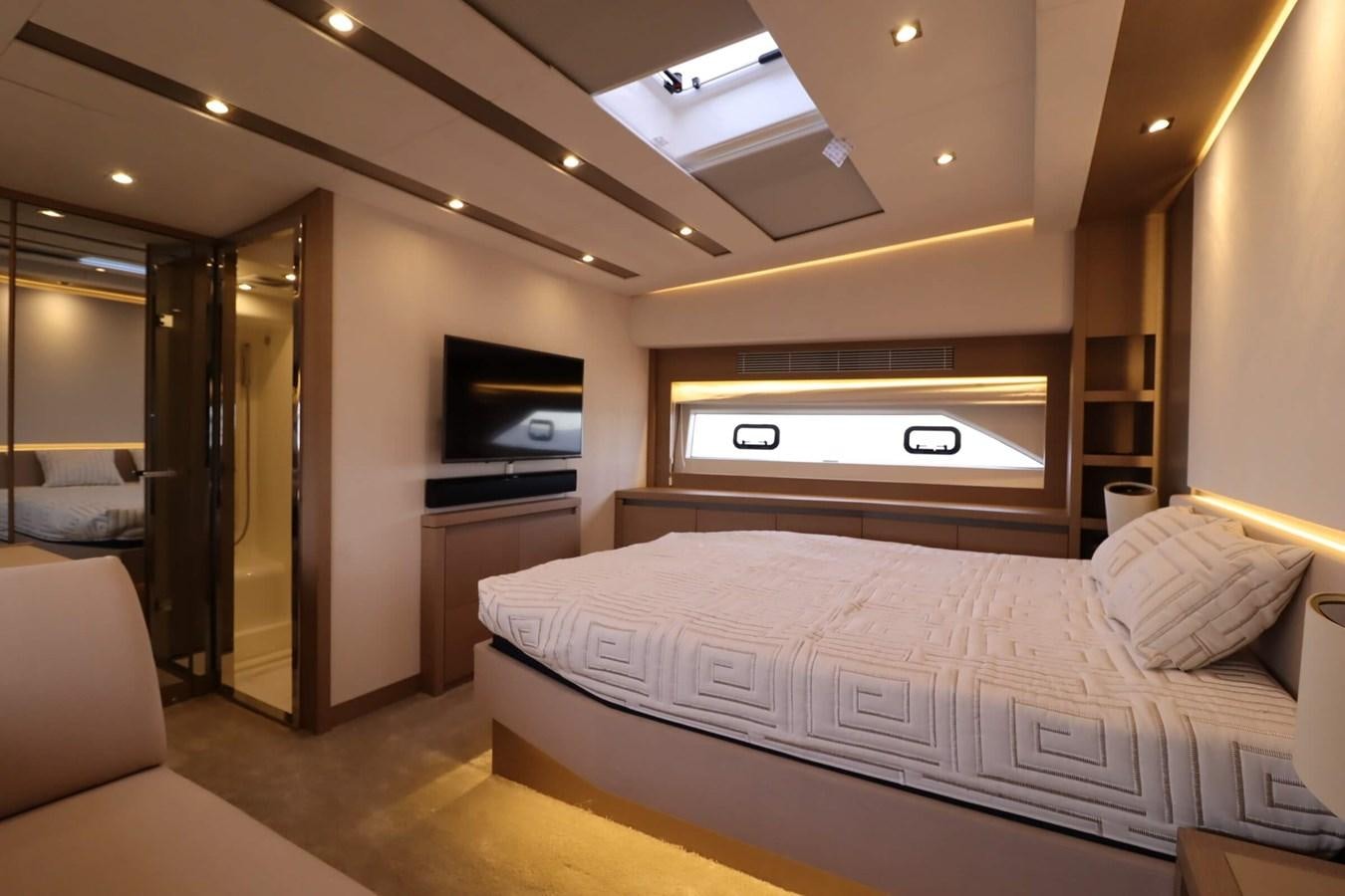 a bedroom with a bed and a television aboard PRESTIGE 680 FLY Yacht for Sale