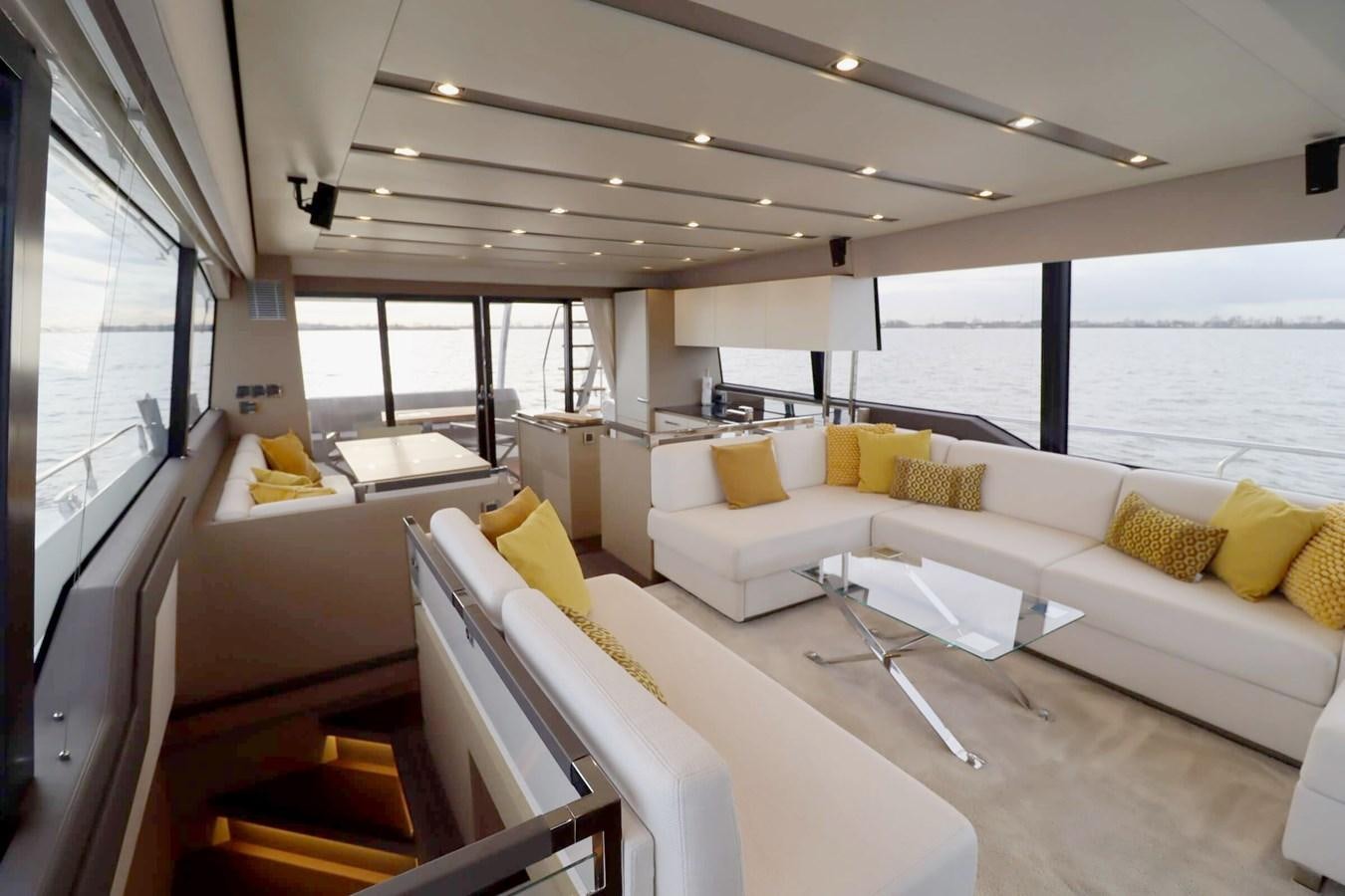 a room with couches and a table aboard PRESTIGE 680 FLY Yacht for Sale