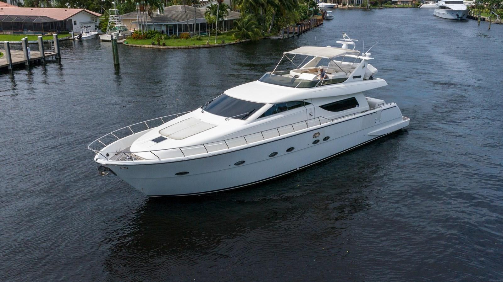 a white boat on the water aboard FOOLISH PLEASURE Yacht for Sale