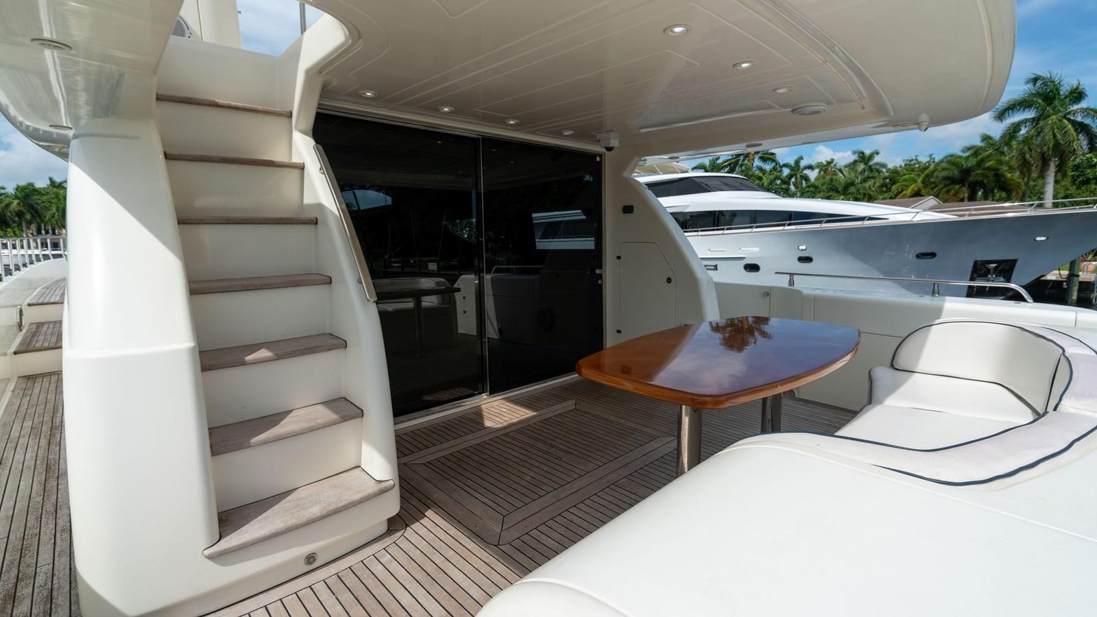 a room with a table and chairs aboard FOOLISH PLEASURE Yacht for Sale