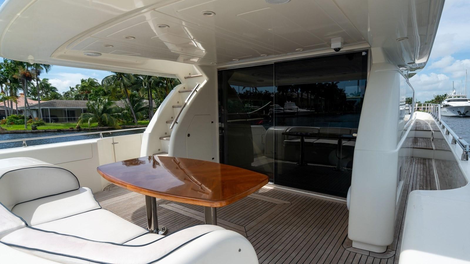 a table and chairs on a deck aboard FOOLISH PLEASURE Yacht for Sale