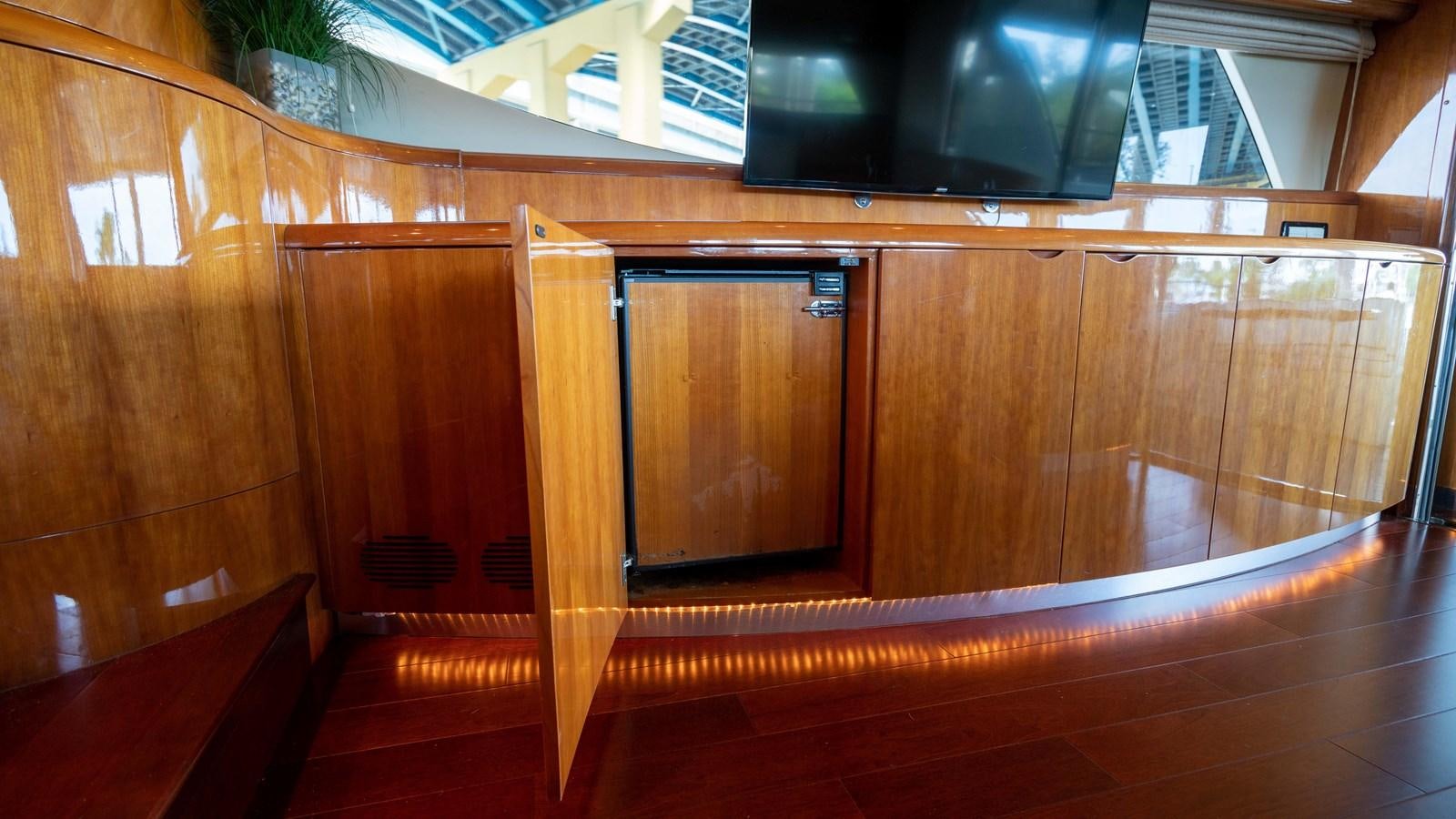 a room with wooden cabinets aboard FOOLISH PLEASURE Yacht for Sale