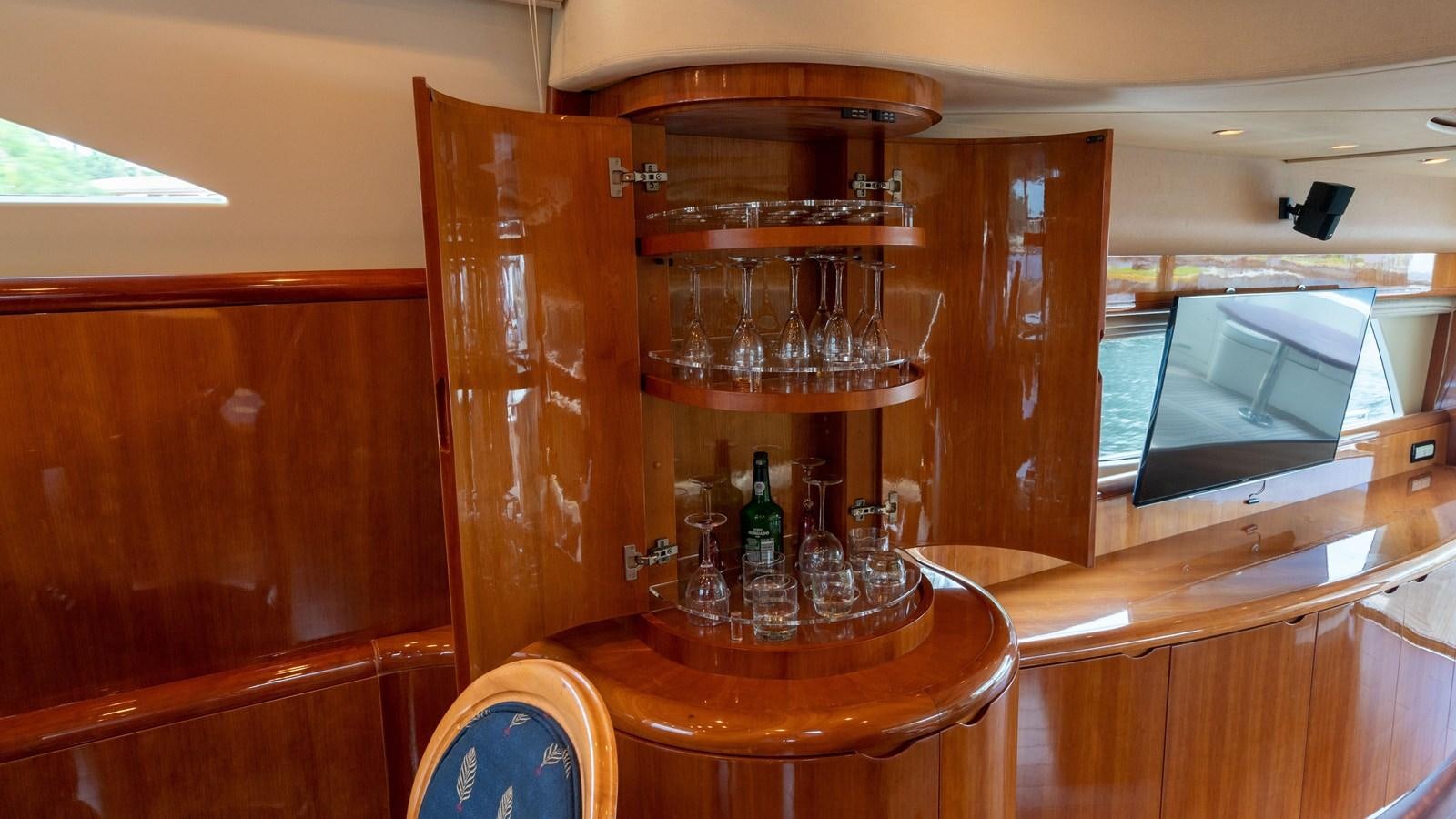 a glass cabinet with a glass shelf aboard FOOLISH PLEASURE Yacht for Sale