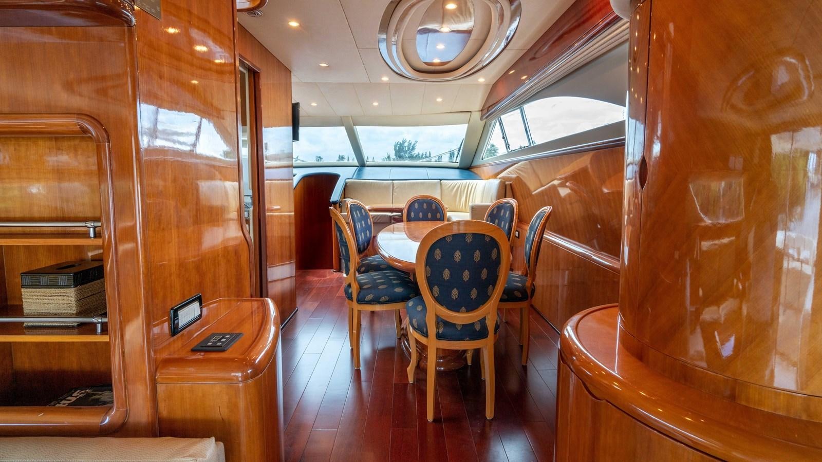 a room with a table and chairs aboard FOOLISH PLEASURE Yacht for Sale