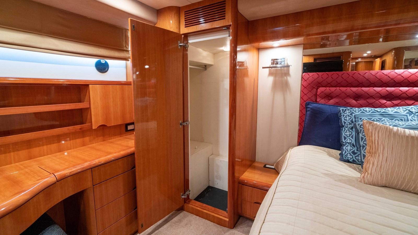 a room with a bed and a closet aboard FOOLISH PLEASURE Yacht for Sale