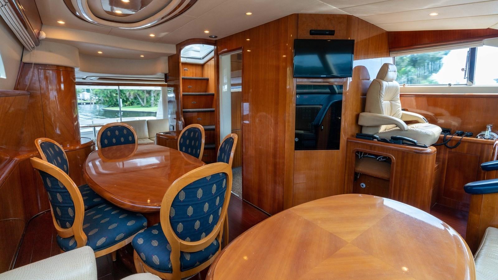 a room with a table and chairs aboard FOOLISH PLEASURE Yacht for Sale