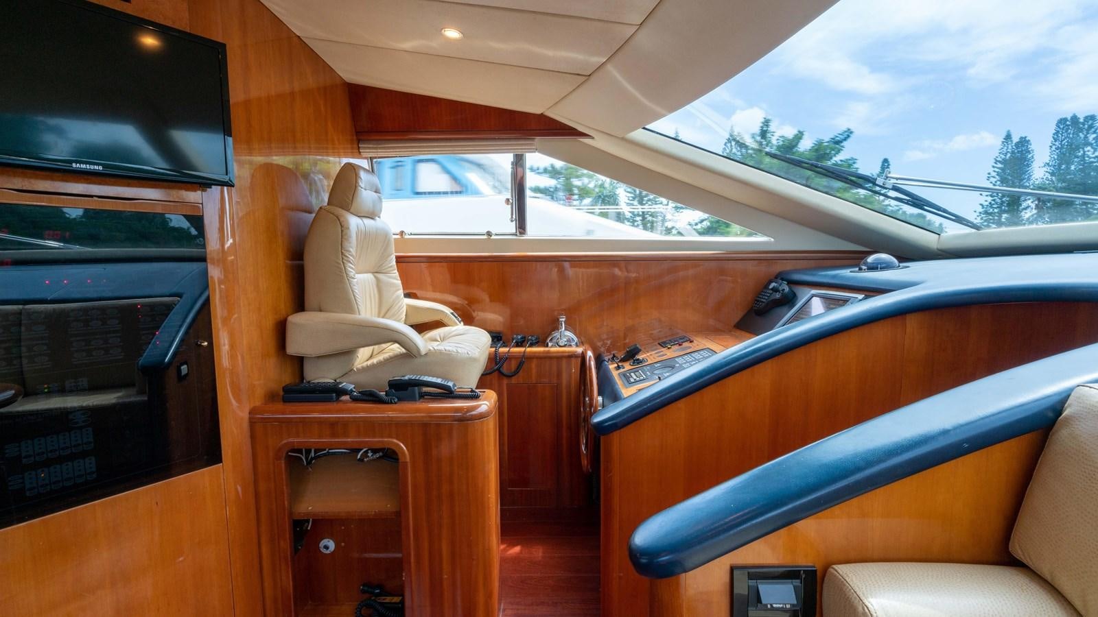 a room with a desk and a television aboard FOOLISH PLEASURE Yacht for Sale