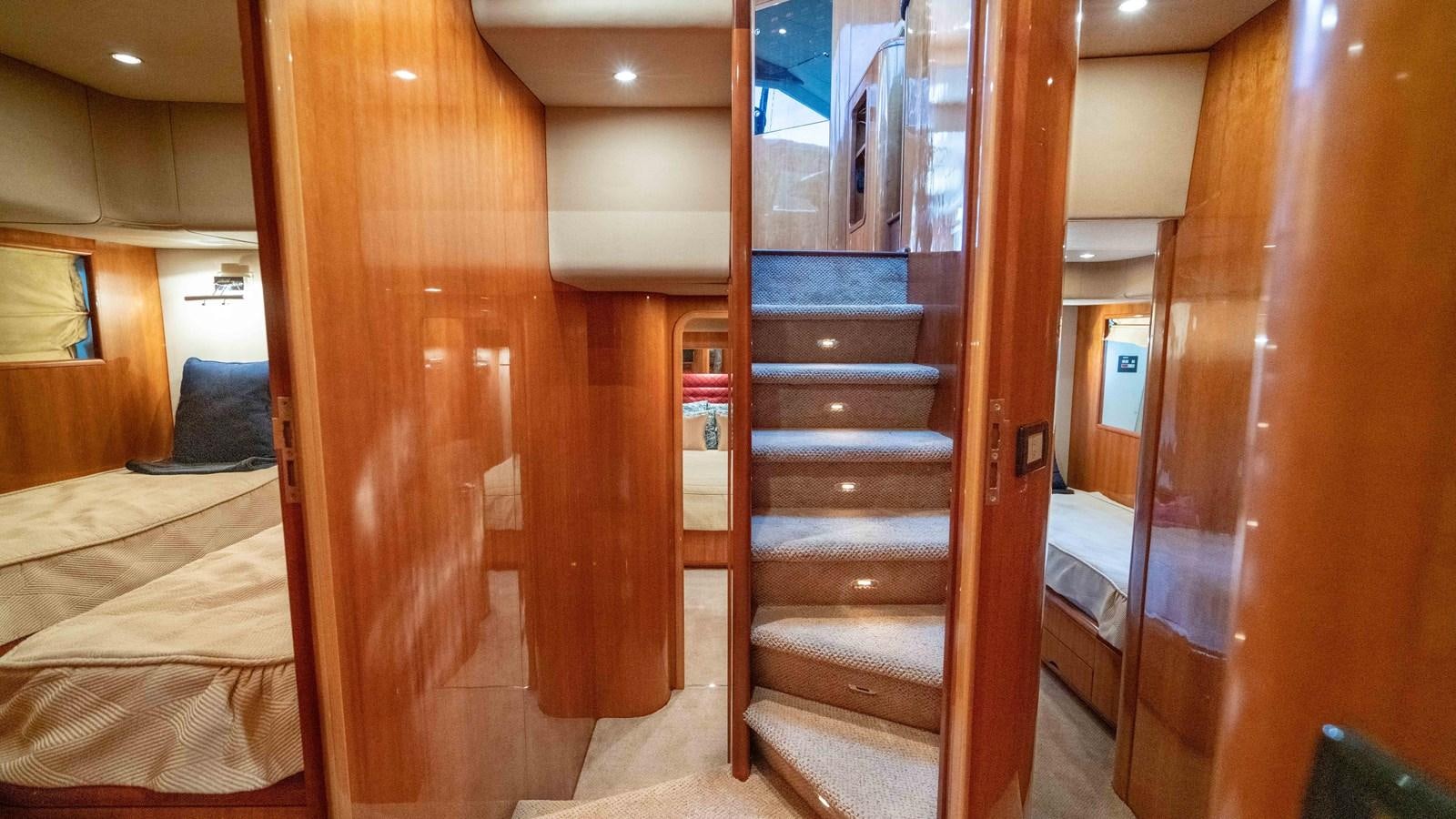 a room with wooden stairs aboard FOOLISH PLEASURE Yacht for Sale
