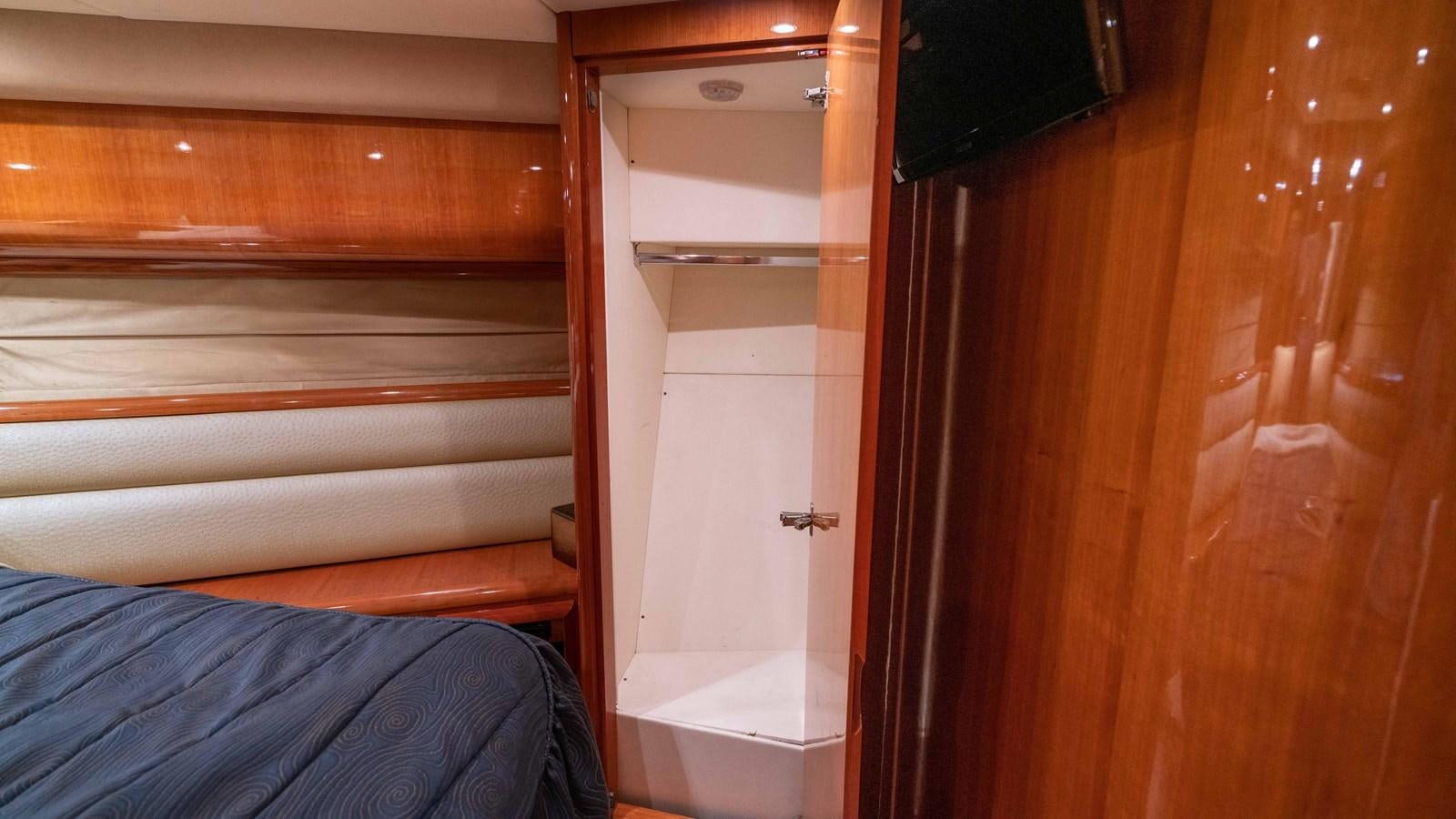 a room with a closet and a bed aboard FOOLISH PLEASURE Yacht for Sale