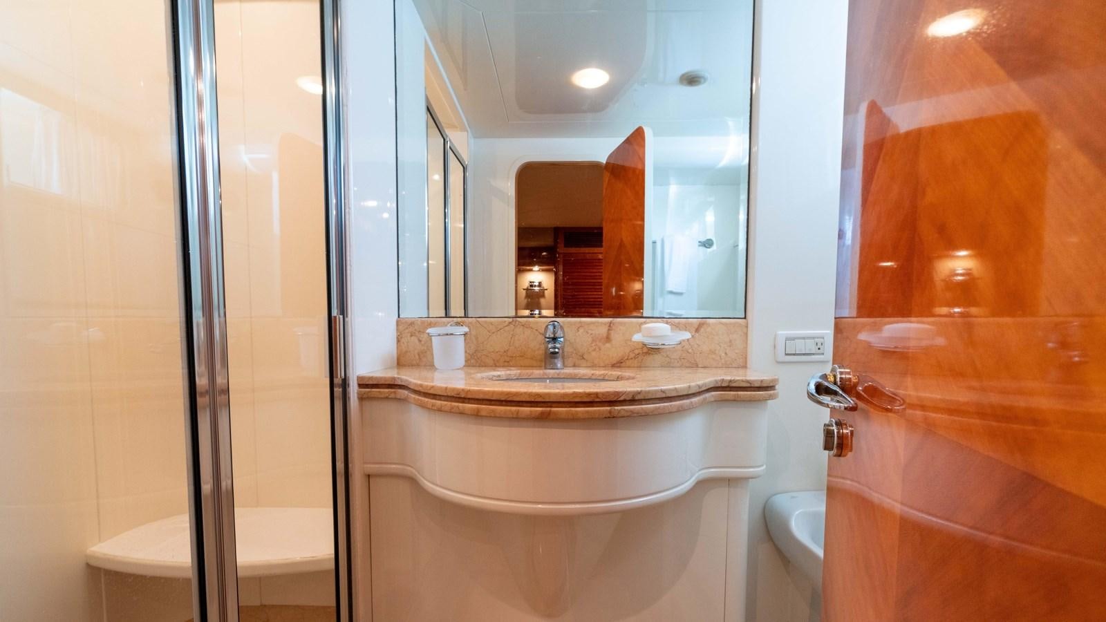 a bathroom with a large mirror aboard FOOLISH PLEASURE Yacht for Sale