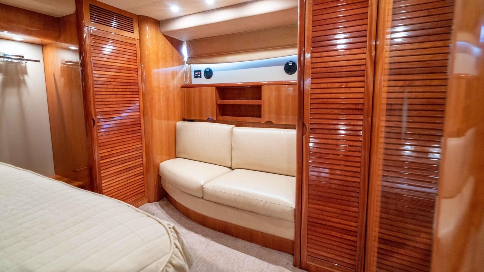 a room with a bed and a couch aboard FOOLISH PLEASURE Yacht for Sale