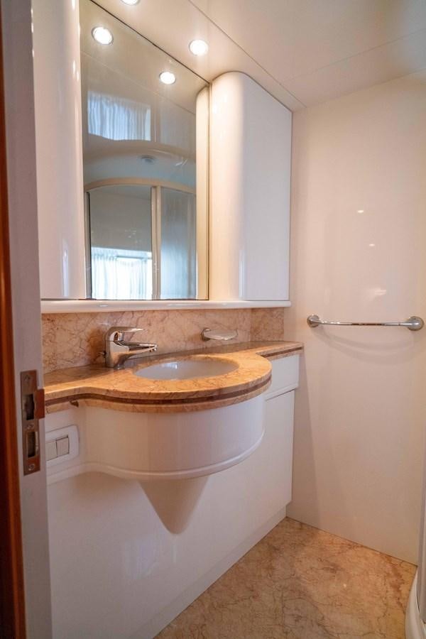 a bathroom with a sink and a mirror aboard FOOLISH PLEASURE Yacht for Sale