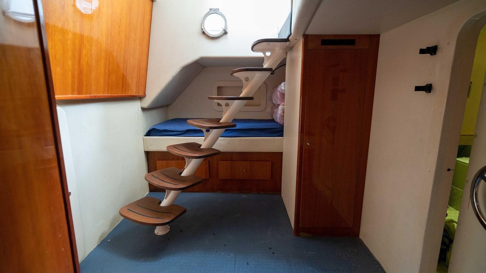 a room with bunk beds aboard FOOLISH PLEASURE Yacht for Sale