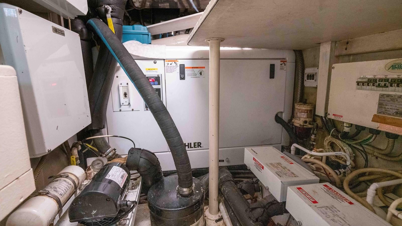 a machine in a room aboard FOOLISH PLEASURE Yacht for Sale