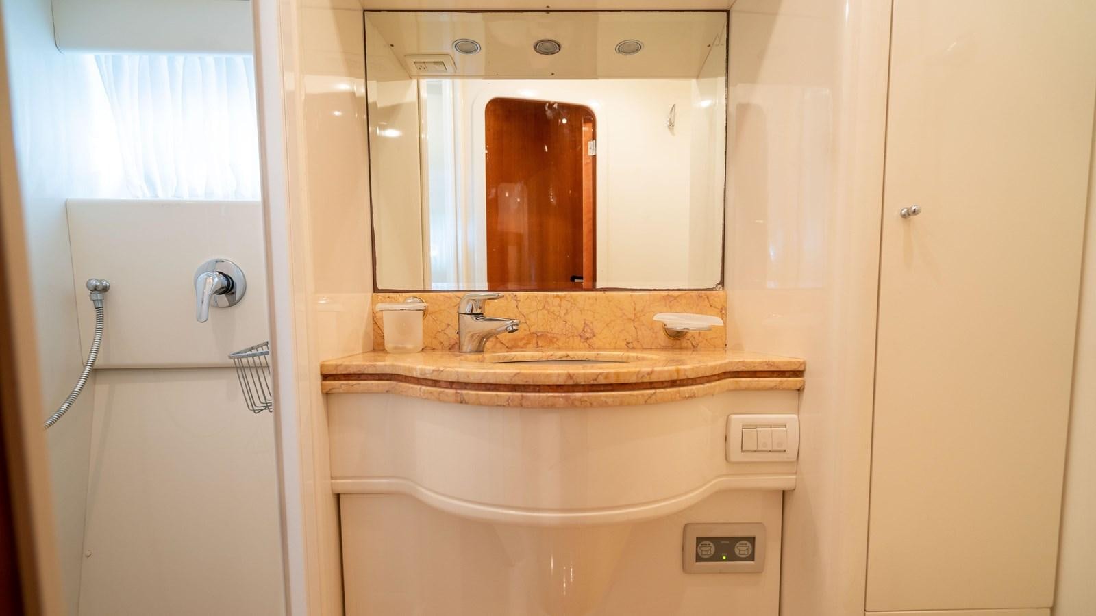 a bathroom with a mirror aboard FOOLISH PLEASURE Yacht for Sale