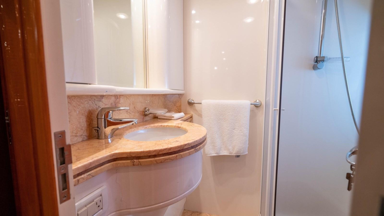 a bathroom with a sink and a mirror aboard FOOLISH PLEASURE Yacht for Sale