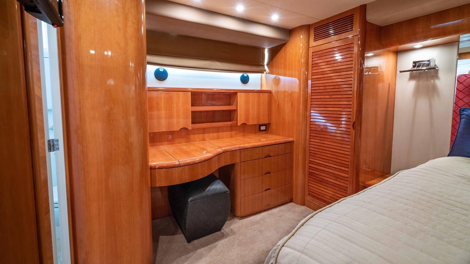 a room with a bed and a desk aboard FOOLISH PLEASURE Yacht for Sale
