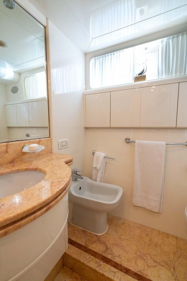 a bathroom with a sink and a toilet aboard FOOLISH PLEASURE Yacht for Sale