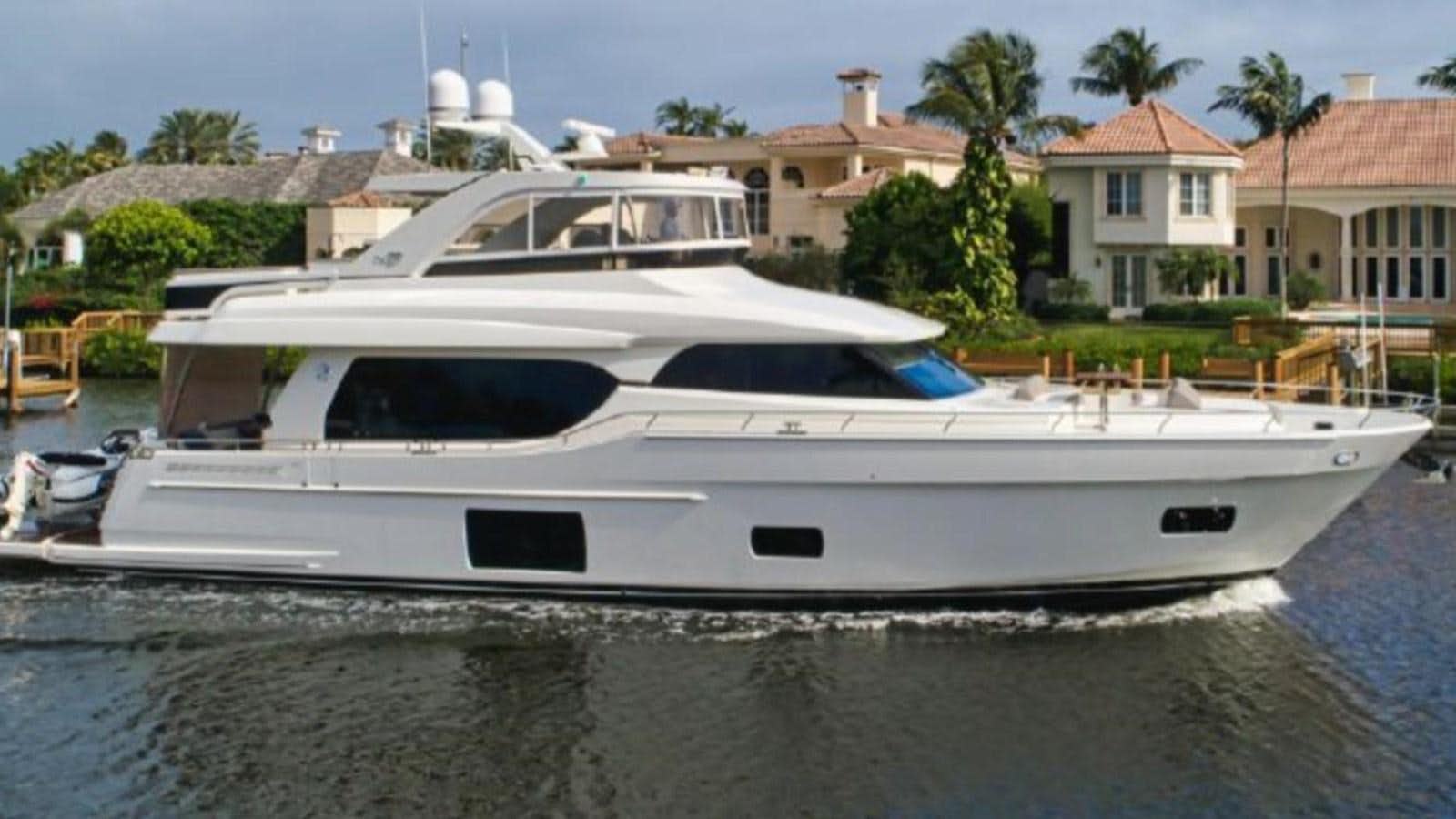 a white yacht in a harbor aboard PLAYBOOK Yacht for Sale