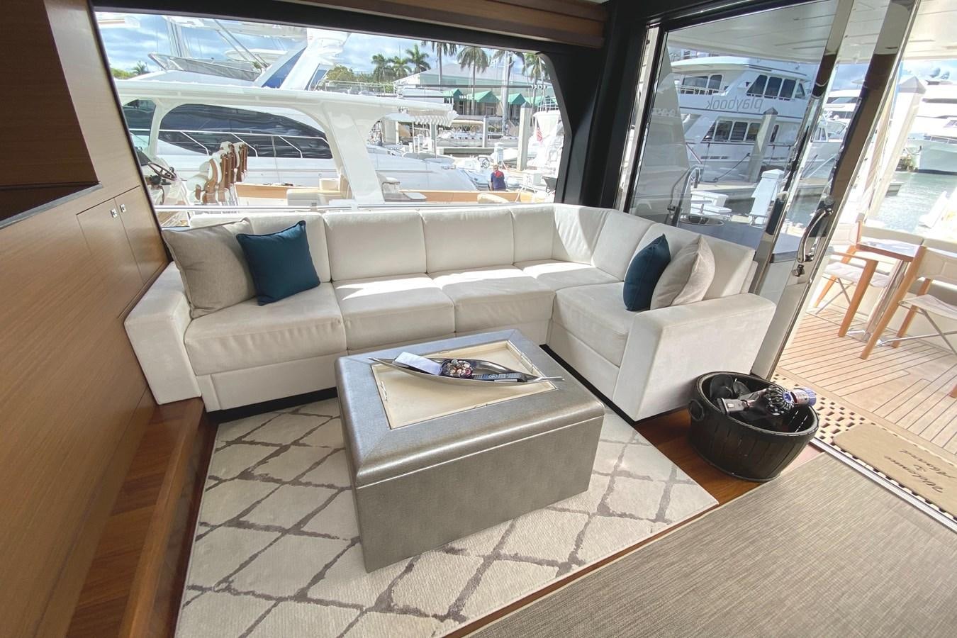 a living room with a couch and a coffee table aboard PLAYBOOK Yacht for Sale