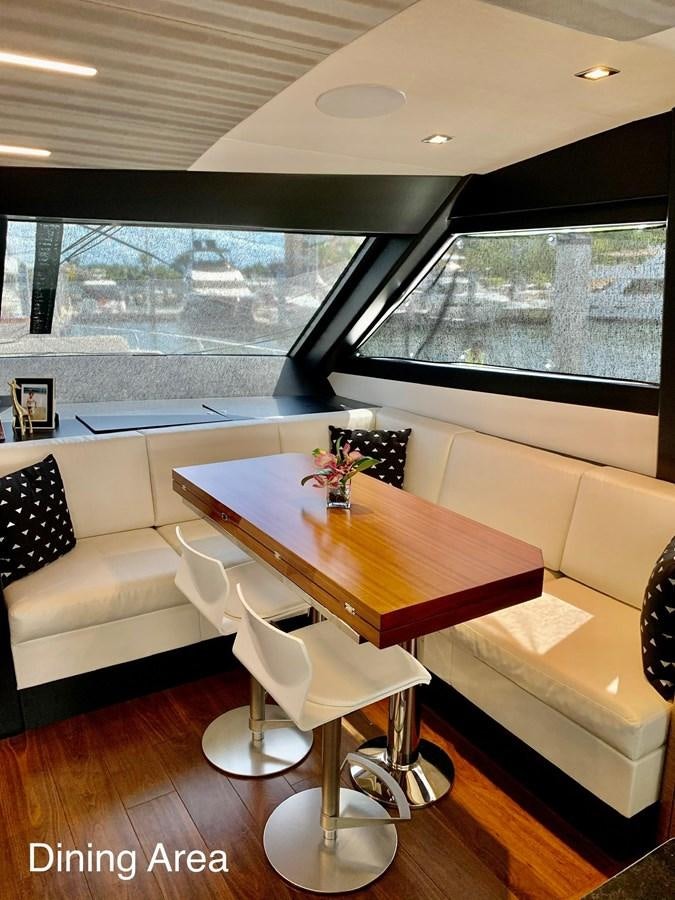 a table and chairs in a room aboard PLAYBOOK Yacht for Sale