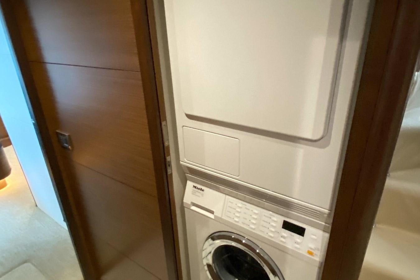 a white washing machine aboard PLAYBOOK Yacht for Sale