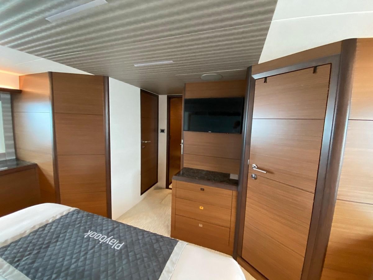 a room with a bed and a closet aboard PLAYBOOK Yacht for Sale