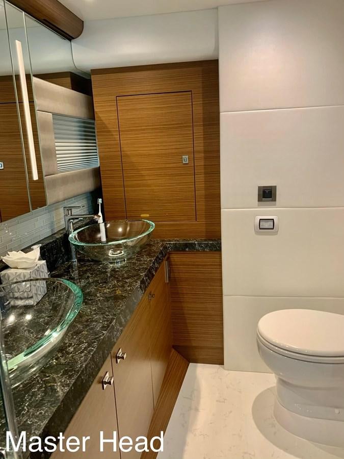 a bathroom with a sink and a toilet aboard PLAYBOOK Yacht for Sale