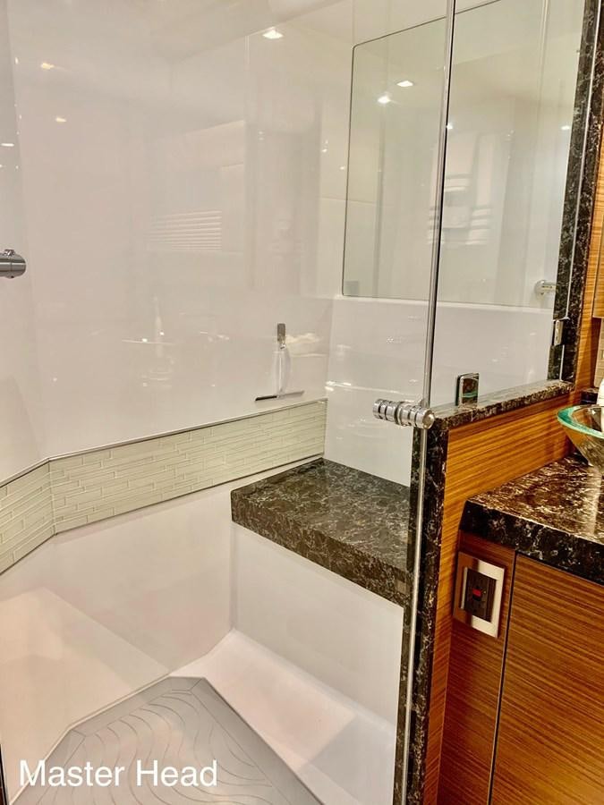 a bathroom with a glass shower aboard PLAYBOOK Yacht for Sale