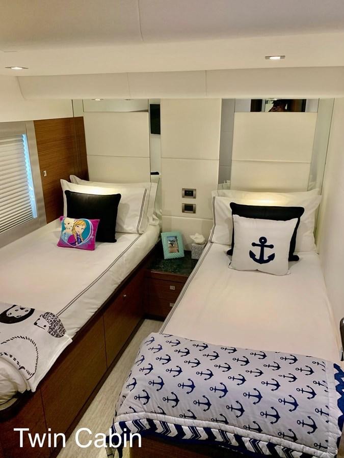 a bedroom with two beds aboard PLAYBOOK Yacht for Sale