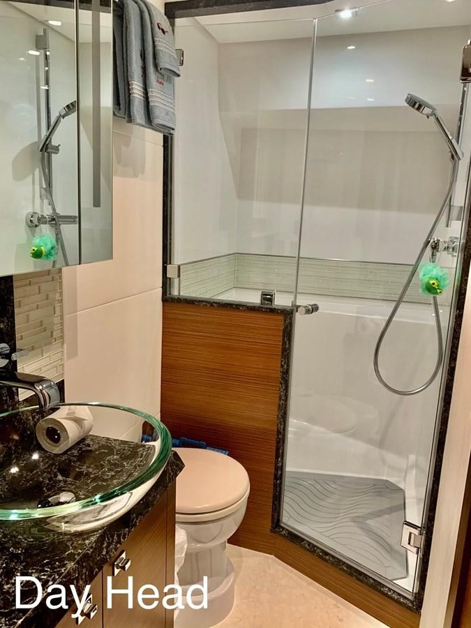 a bathroom with a glass shower aboard PLAYBOOK Yacht for Sale