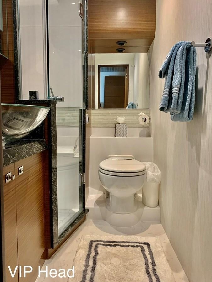 a bathroom with a toilet and a sink aboard PLAYBOOK Yacht for Sale
