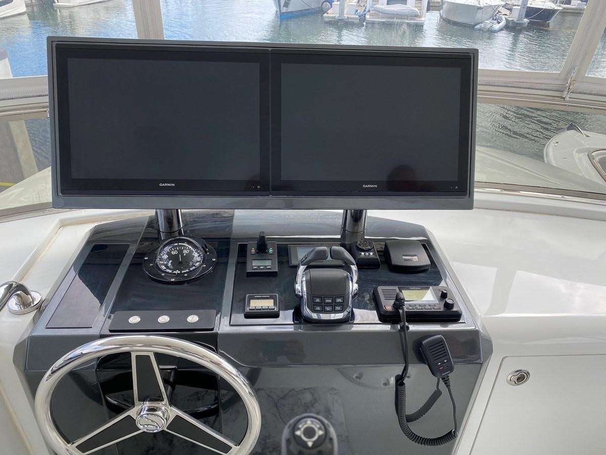 a computer with a screen and other electronic devices on it aboard PLAYBOOK Yacht for Sale