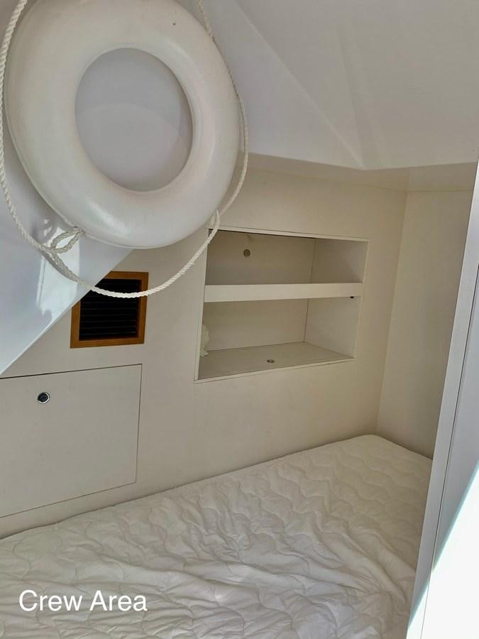 a white room with a white bed and a white wall aboard PLAYBOOK Yacht for Sale