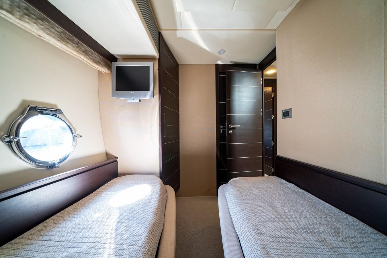 a bedroom with a bed and a tv aboard AROMA Yacht for Sale