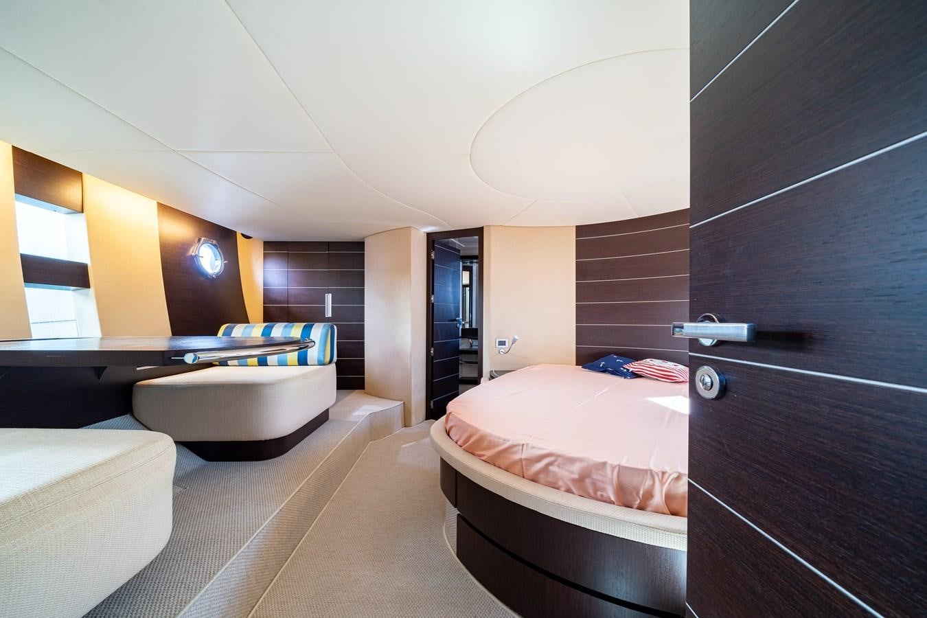 a room with a bed and a desk aboard AROMA Yacht for Sale
