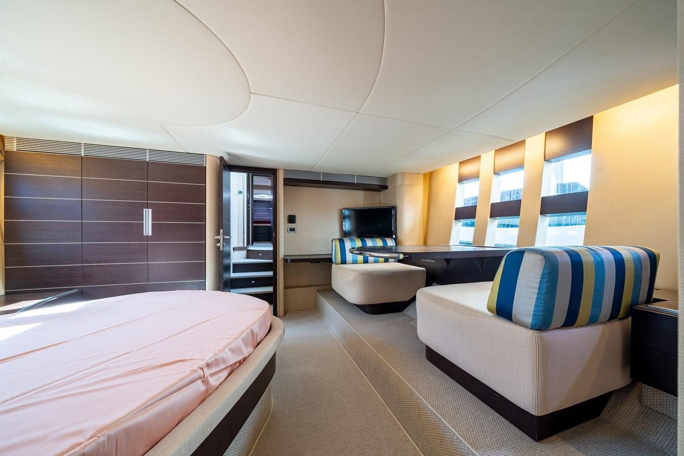 a bedroom with a bed and a television aboard AROMA Yacht for Sale