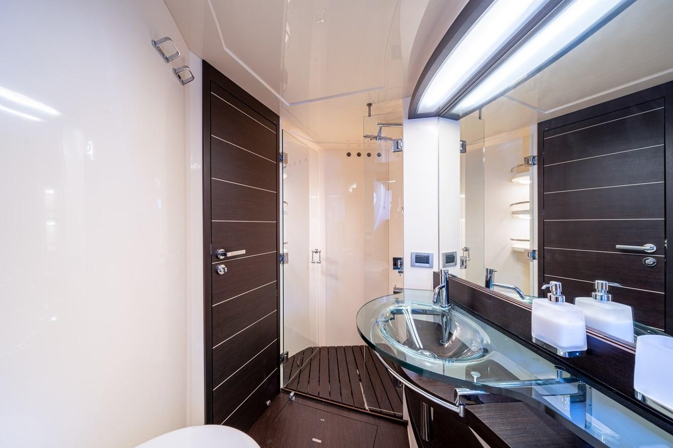 a bathroom with a large mirror aboard AROMA Yacht for Sale