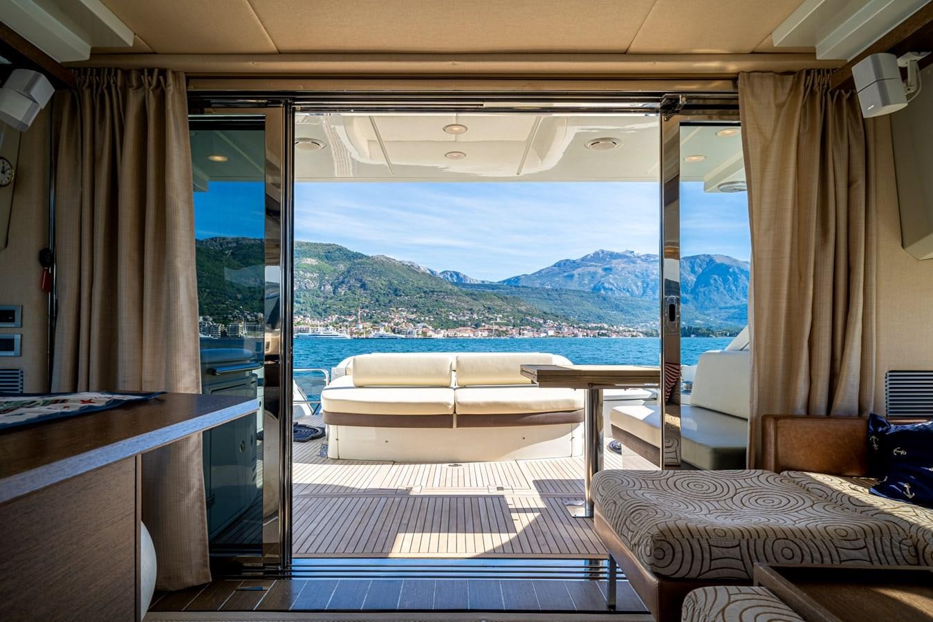 a room with a view of the ocean and a large bed aboard AROMA Yacht for Sale