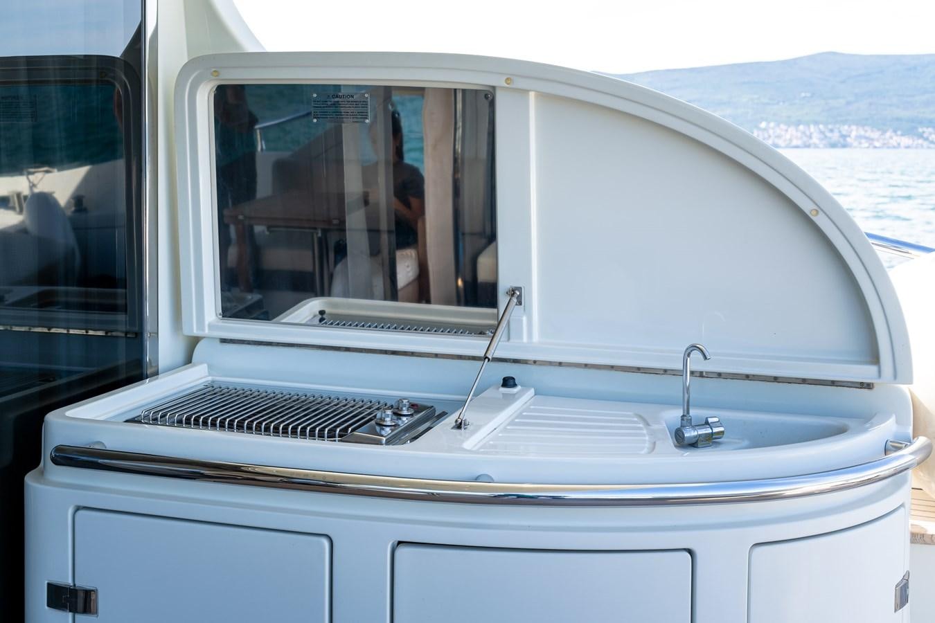 a white car with a door open aboard AROMA Yacht for Sale