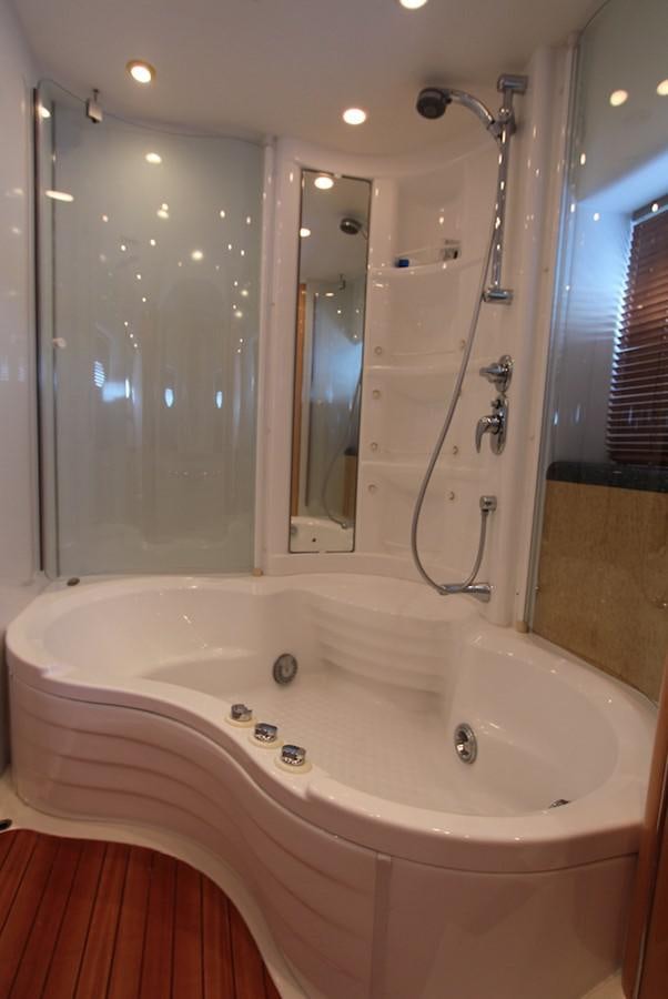 a bathtub with a shower head aboard NIKA Yacht for Sale