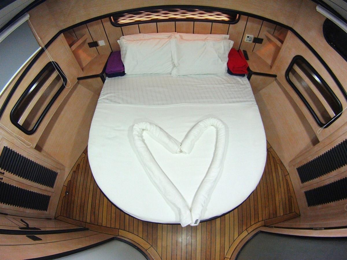a bed with a white sheet aboard NOSTALGIA Yacht for Sale