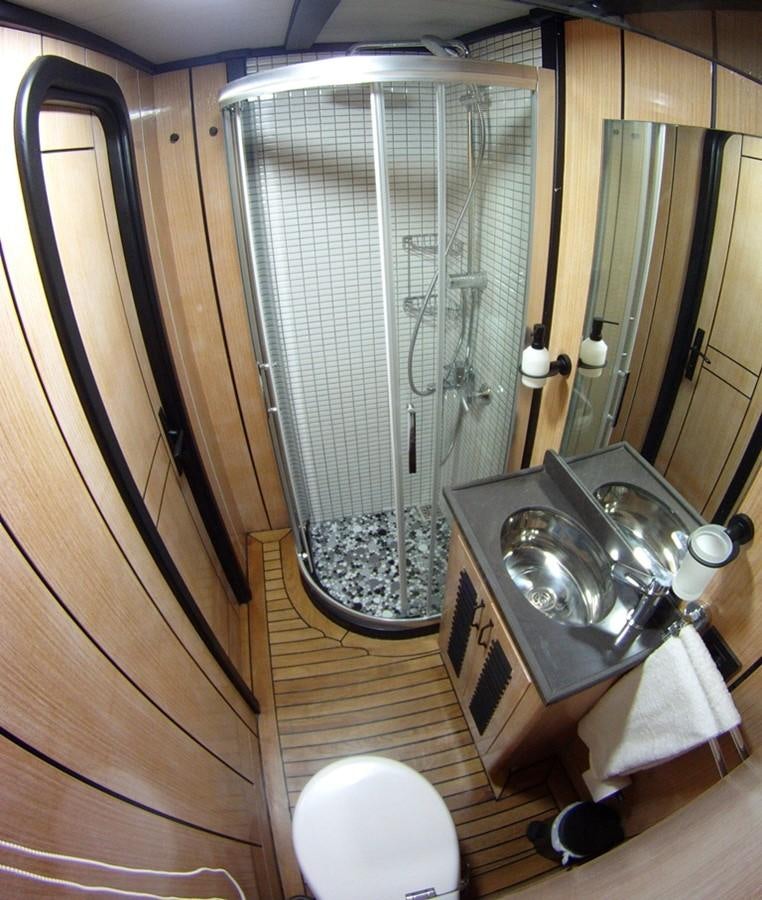 a bathroom with a glass shower aboard NOSTALGIA Yacht for Sale